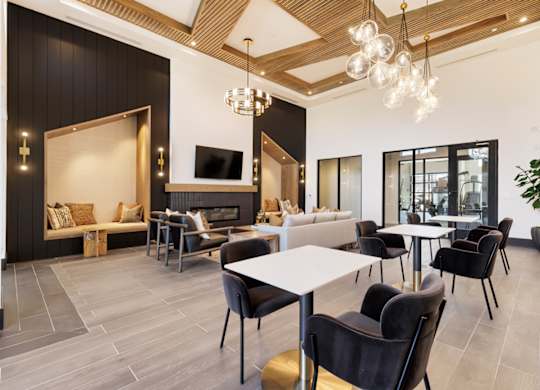 A modern living room with a fireplace and a dining area.