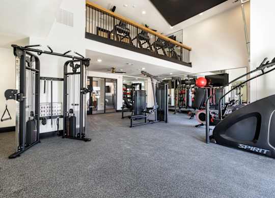 A gym with a variety of equipment including a rowing machine.