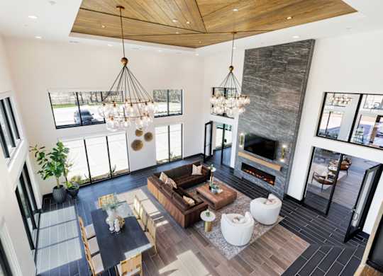A modern living room with a fireplace and a large window.