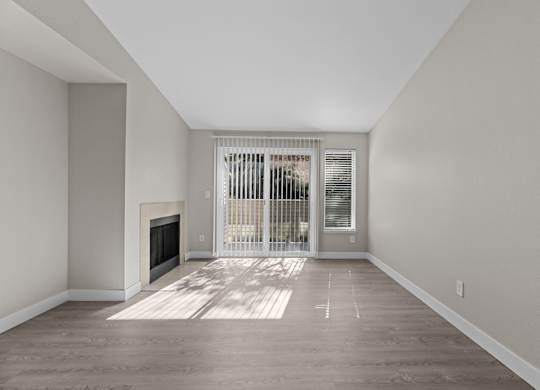 The Marina at Martha Lake Apartments in Bothell, WA Living Room with Fireplace and Private Patio