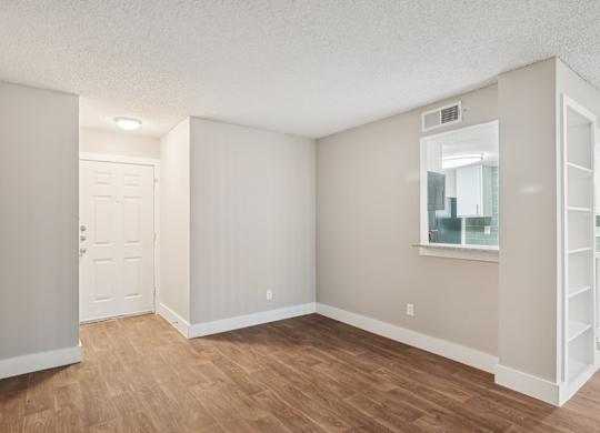 A room with a white door and a window with a white frame.