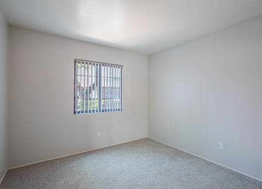 A room with a window and a car outside.