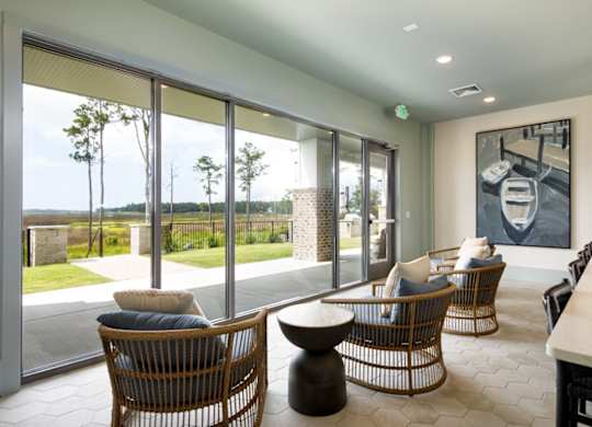 A room with a large window and a painting of a car on the wall.