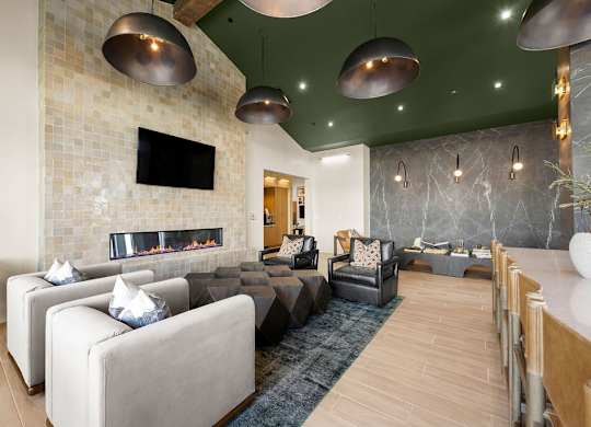 A modern living room with a fireplace and a flat screen TV.