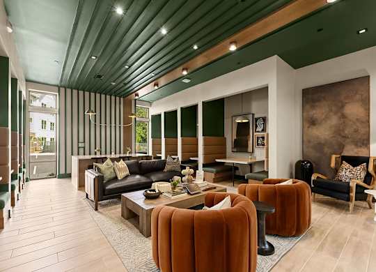 A modern living room with a black couch and a wooden coffee table.