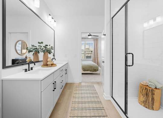 A bathroom with a white sink and a mirror above it.