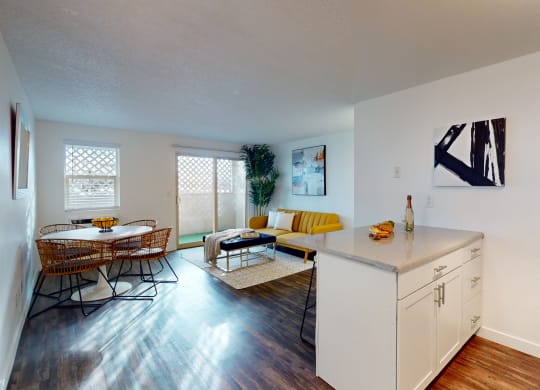 a living room and dining room with a table and chairs