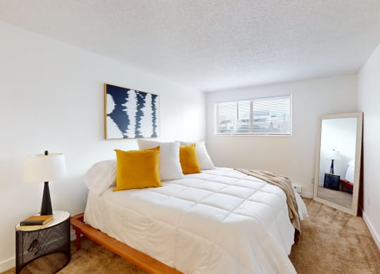 a bedroom with a large bed and a mirror