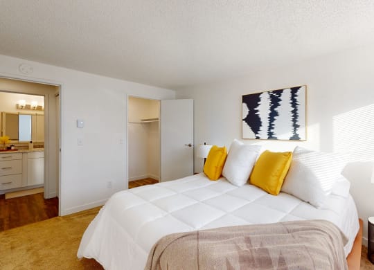 a bedroom with a large bed and a bathroom