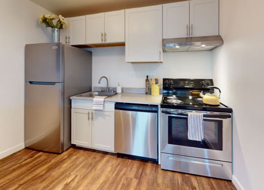a kitchen with stainless steel appliances and a refrigerator
