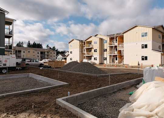 A construction site with a building under construction in the background.