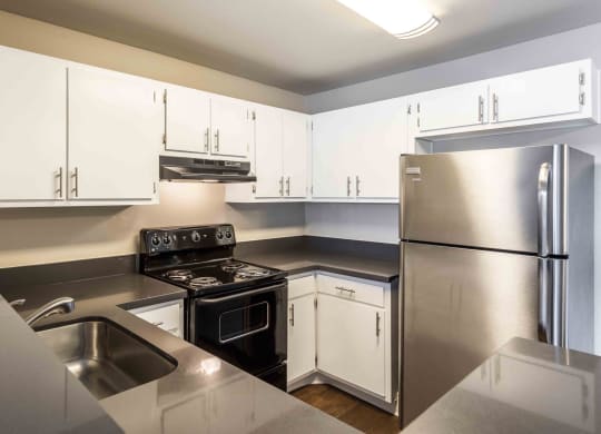 a kitchen with stainless steel appliances and white cabinets