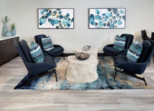 a living room with four chairs and a coffee table