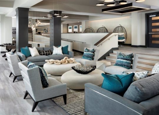 a living room filled with furniture and a staircase