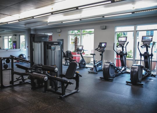 a gym with cardio equipment and weights in a building