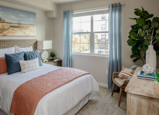 WestEndDistrict_Beaverton_OR_photos_bedroom with a large bed and a desk with a chair