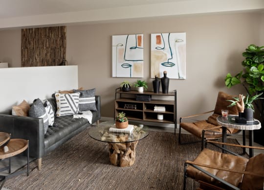 a living room filled with furniture and a large painting on the wall
