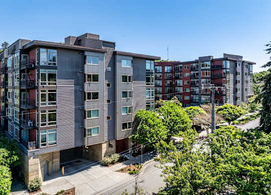 A modern apartment complex with multiple buildings and balconies.