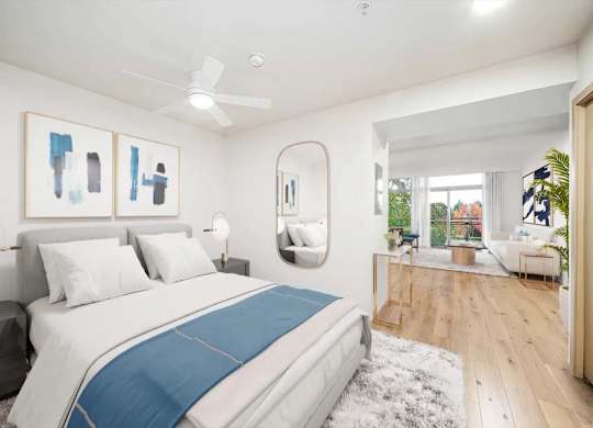 A bedroom with a large bed and a ceiling fan.
