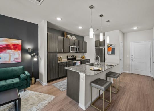 a kitchen and living room with a marble counter top