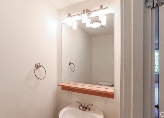A bathroom with a white sink and a mirror above it at Park87 Apartments, Cambridge, MA, 02138