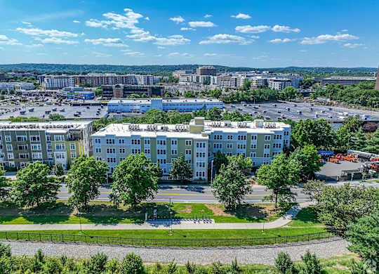 A large white building with a green lawn in front of it at Park87 Apartments, Massachusetts, 02138