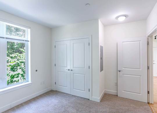 A bedroom with a window and spacious closets at 7 Cameron Apartments, Cambridge