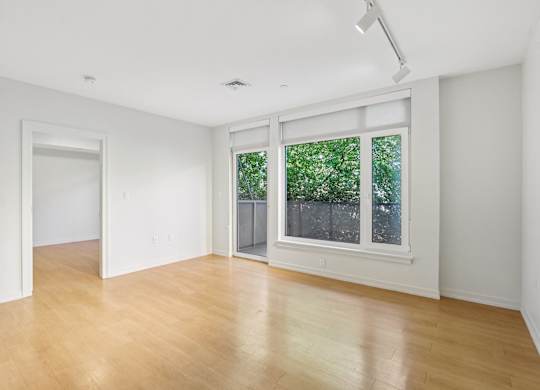 Living room with wooden floor and patio at Park77 Apartments, Massachusetts, 02138