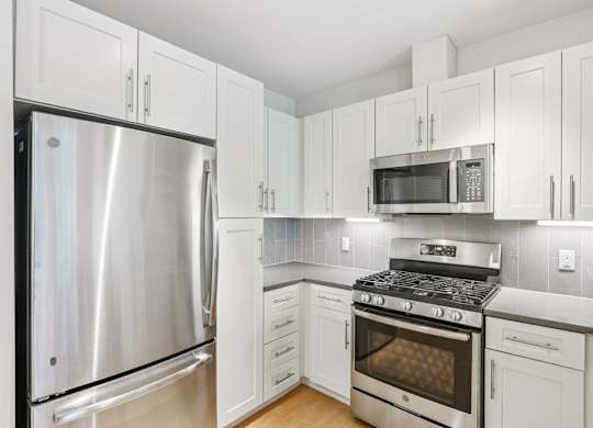 Kitchen with white cabinetry at Park77 Apartments, Massachusetts, 02138