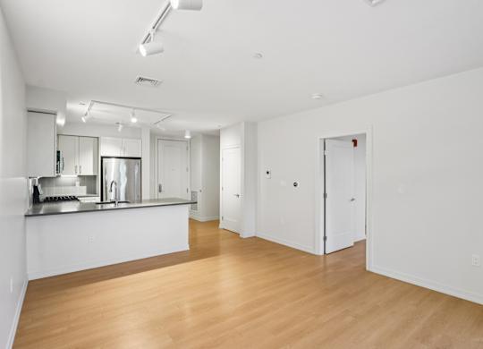 Spacious living room with kitchen view at Park77 Apartments, Cambridge, 02138