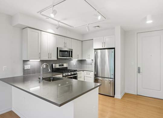 Kitchen with stainless steel refrigerator, microwave, and oven at Park77 Apartments, Massachusetts, 02138