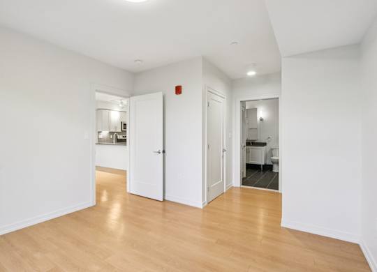 Bedroom with wooden floors and white walls  at Park77 Apartments, Cambridge, MA