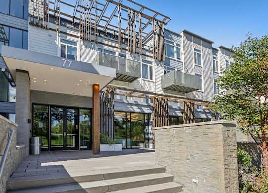 Modern building with a glass facade and a stone entrance at Park77 Apartments, Cambridge, Massachusetts, 02138