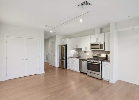 Kitchen with white cabinets and stainless steel appliances at Park77 Apartments, Cambridge, Massachusetts, 02138
