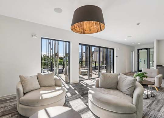 Modern living room with a large window and a view of the city at Park77 Apartments, Cambridge, MA