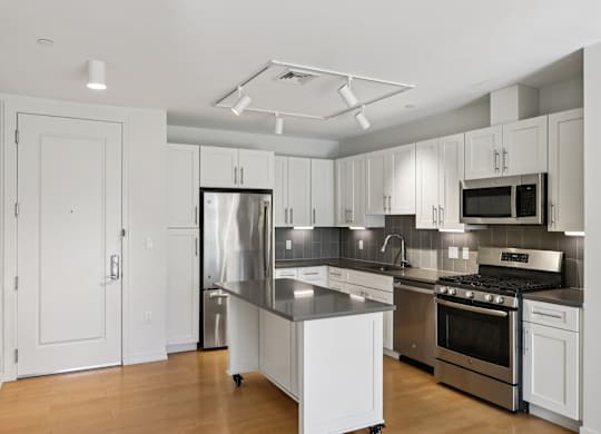 Beautifully decorated kitchen with white furniture at Park77 Apartments, Cambridge, 02138