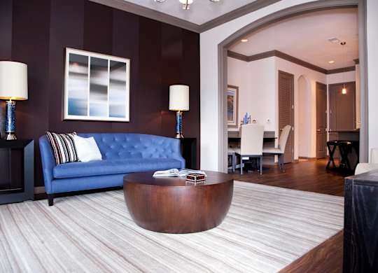 a living room with a blue couch and a coffee table