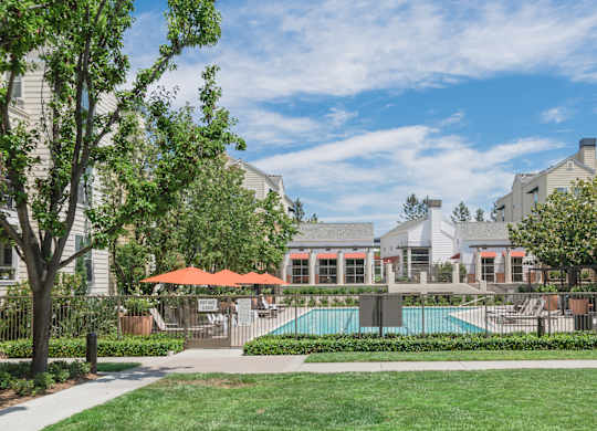 A sunny day at a residential complex with a swimming pool.