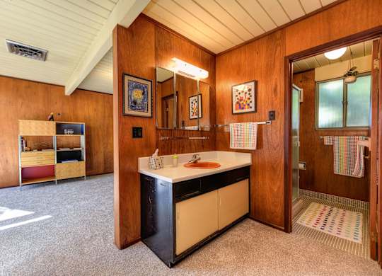 A kitchen area with a sink and a refrigerator.