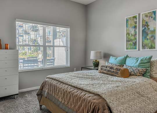 a bedroom with a bed and a large window