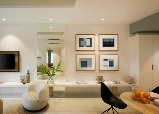 a living room with a desk and a television