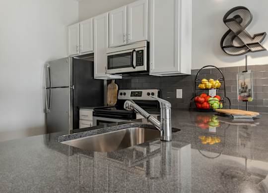 a kitchen with stainless steel appliances and a sink