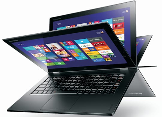 a laptop computer sitting on top of another laptop computer