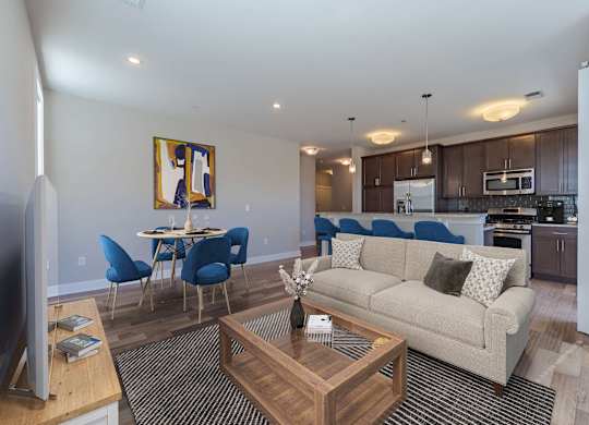 A living room with a couch, chairs, and a coffee table.