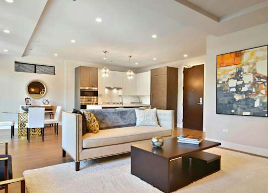 A modern living room with a white couch and a coffee table.