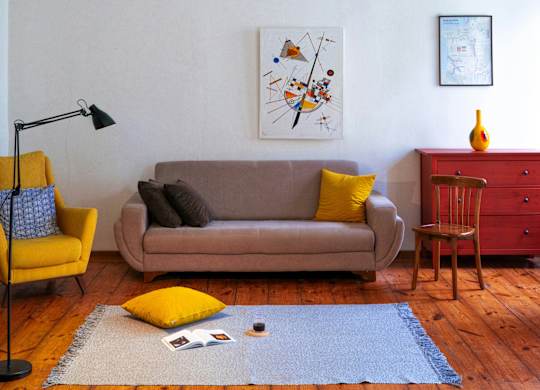 a living room with a couch and a chandelier