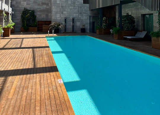 A modern house with a pool in the backyard.