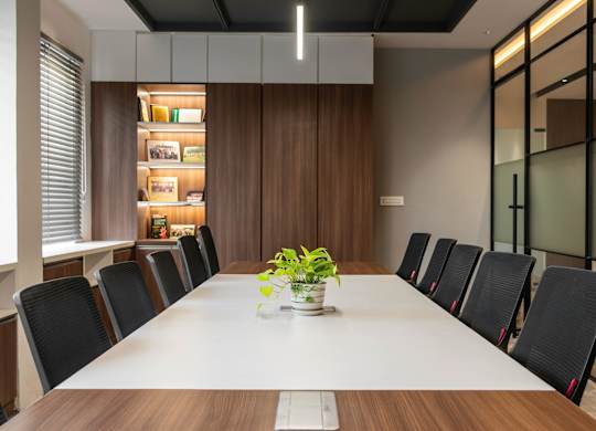 A conference room with a long table and chairs.