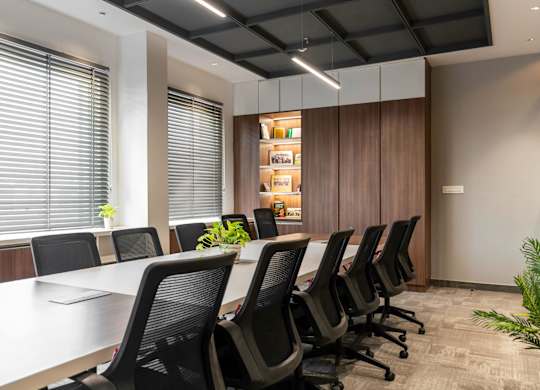 A conference room with a long table and chairs.