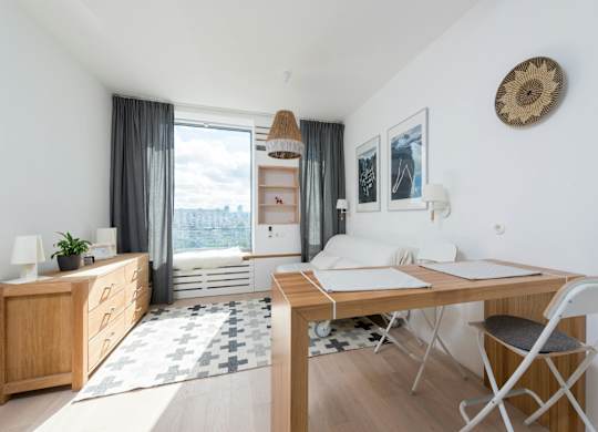 A room with a desk and a chair in it.